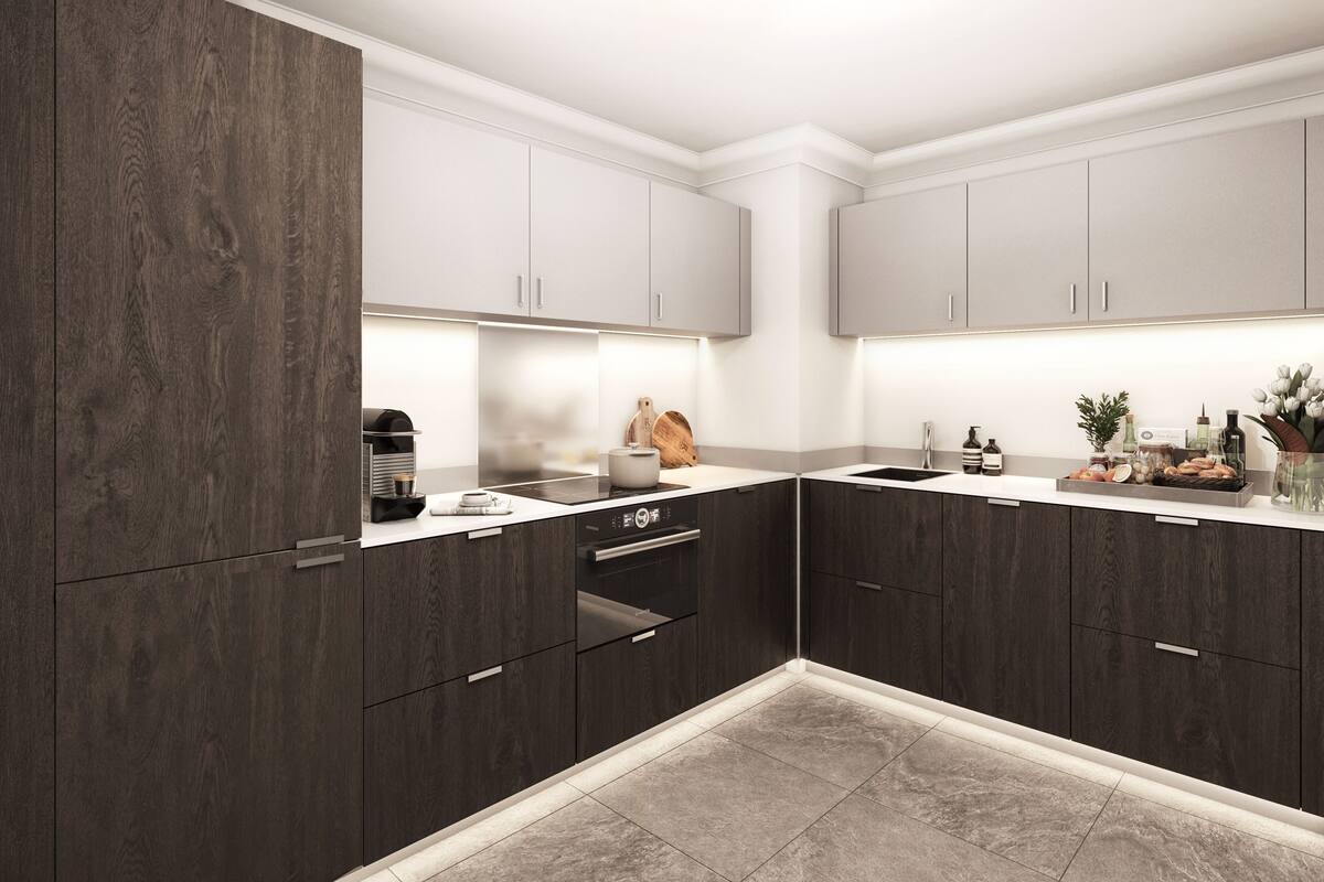 A modern kitchen with dark wood cabinets, a built-in oven, and a countertop with various items.