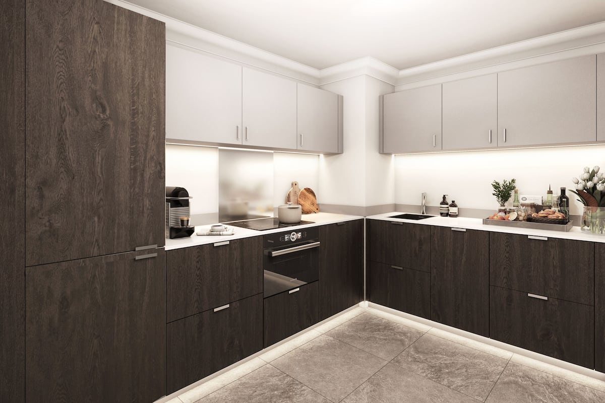 A modern kitchen with dark wood cabinets, a built-in oven, and a countertop with various items.