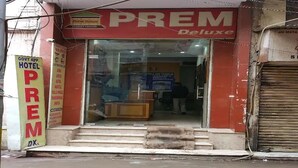 A hotel entrance with a sign reading "PREM Deluxe" and a "GOVT Approved Hotel" sign. - Hotel Prem Deluxe Guest House (New Delhi)