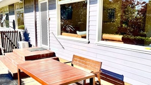 A patio with a wooden table and bench, a small staircase, and a window with a view of trees. - Prime Spot! 5mins to “Grand Cliff Top Walk” & “3 Sisters” (Katoomba)