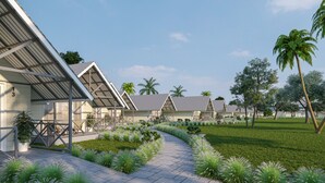 Fila de edificios modernos de una sola planta con un paseo techado y jardines bien cuidados.