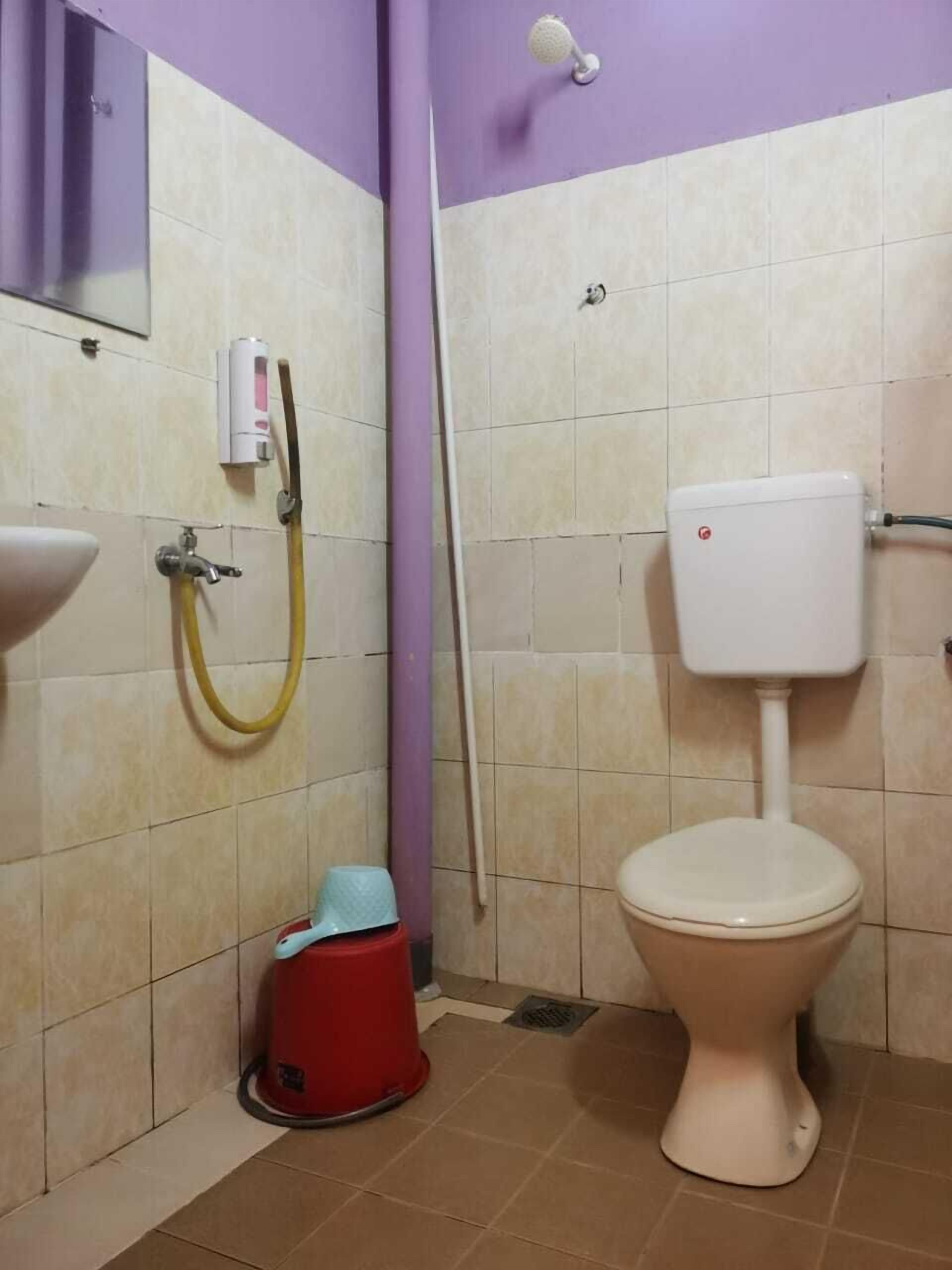 A bathroom with a toilet, sink, and shower.