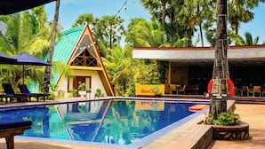 A pool area with lounge chairs, a lifebuoy, and a sign for 'Ree Cha'. - Reecha Kurinji Resort (Iyakachchi)