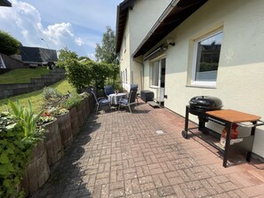 A patio with a grill, outdoor seating, and a brick pathway. - Gemütliche Fewo, Ruhige Lage Direkt Über dem Rheintal Gegenüber der Loreley (Sankt Goar)