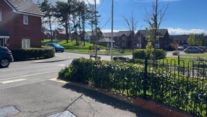 A residential area with houses, a parking lot, and a street. - Remarkable 3-bed House in Wirral (Wirral)