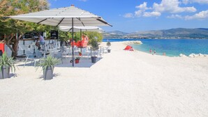 A beachside café with outdoor seating and a view of the sea. - A1 apt With Balcony and sea View, 3 min to Beach (Trogir)
