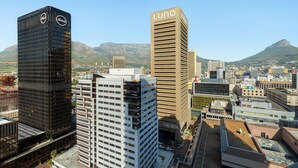 A cityscape with modern buildings, including a prominent Luno building. - One Thibault 1628 (Cape Town)