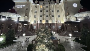 A large, historic hotel with a grand facade, multiple balconies, and a prominent entrance. - ALEXANDER HOTEL (Samarkand)