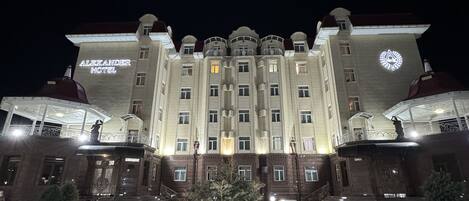 A large, historic hotel with a grand facade, multiple balconies, and a prominent entrance.