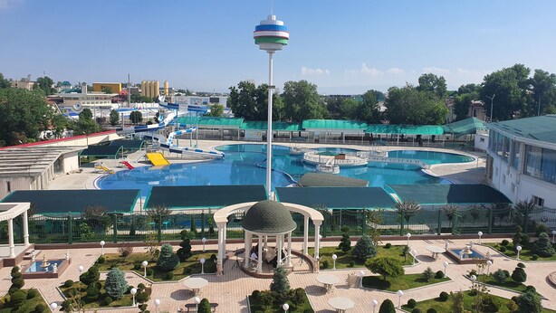 A water park with multiple pools, slides, and a gazebo. - ALEXANDER HOTEL (Samarkand)