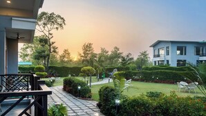 A hotel with a well-maintained garden, a clear pathway, and a seating area.