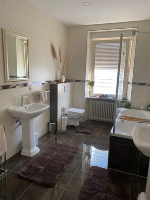 Shower, hair dryer, towels, toilet paper