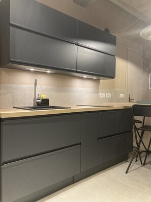 Fridge, microwave, stovetop, coffee/tea maker