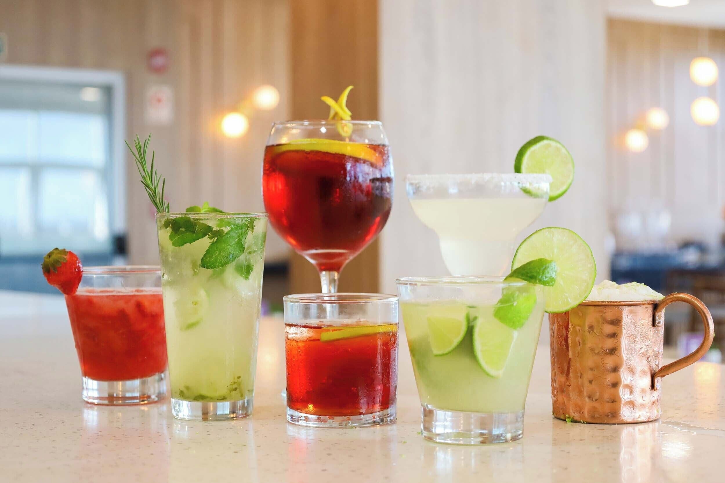 A variety of cocktails on a bar counter.