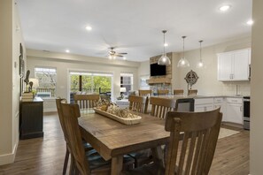 Enjoy meals in this well-equipped kitchen with a central island, dining table, and oven.