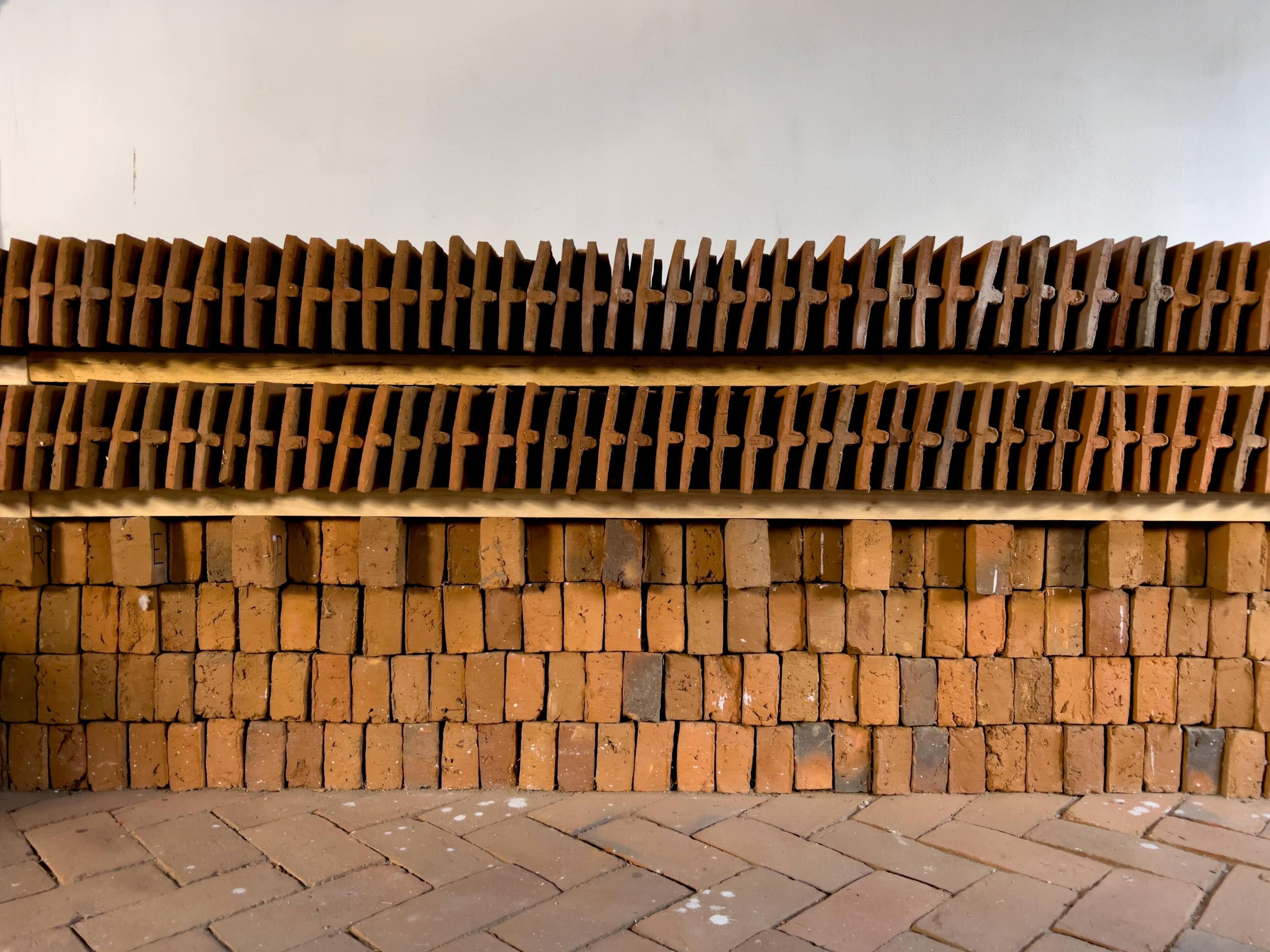 A wall with a brick pattern and a metal grid structure.
