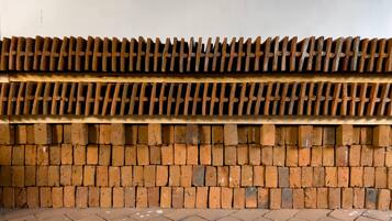 A wall with a brick pattern and a metal grid structure.