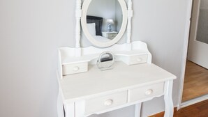 A white vanity with a mirror, two drawers, and a small round mirror on the vanity. - Modern apt with Increbilbe Athens Views (Galatsi)
