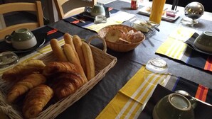 A breakfast setting with bread, croissants, and a beverage. - The southern sun - 4 people (ST JEAN DE VALERISCLE)