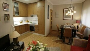 A compact living space with a kitchen, dining area, and a small seating area.