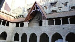 A medieval-style building with arched windows and a central tower.