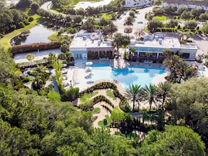 A resort with a large central pool, multiple guest rooms, and lush landscaping. - Great Escape to the Enclaves Near Disney! (Davenport)