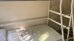 A bunk bed with a grey headboard and a white mattress. - Eco-Shared Hype  (Miami)