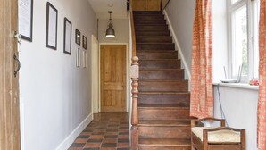 Eine Treppe mit Holzboden und einer Holztür am oberen Ende.