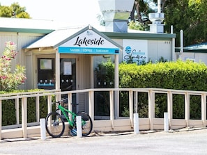 A Lakeside establishment with a sign indicating it offers a tavern, coffee, and takeaway services.