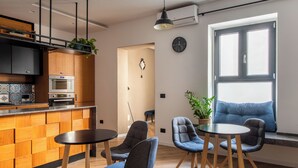 A modern kitchen with built-in appliances, a dining area with chairs and a table, and a large window with a view. - Villena Plaza by Wonderful Italy (Palermo)