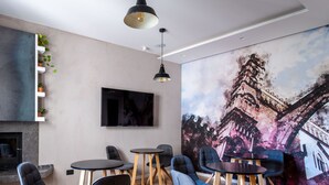 A modern living room with a fireplace, flat-screen TV, and a large abstract painting. - Villena Plaza by Wonderful Italy (Palermo)