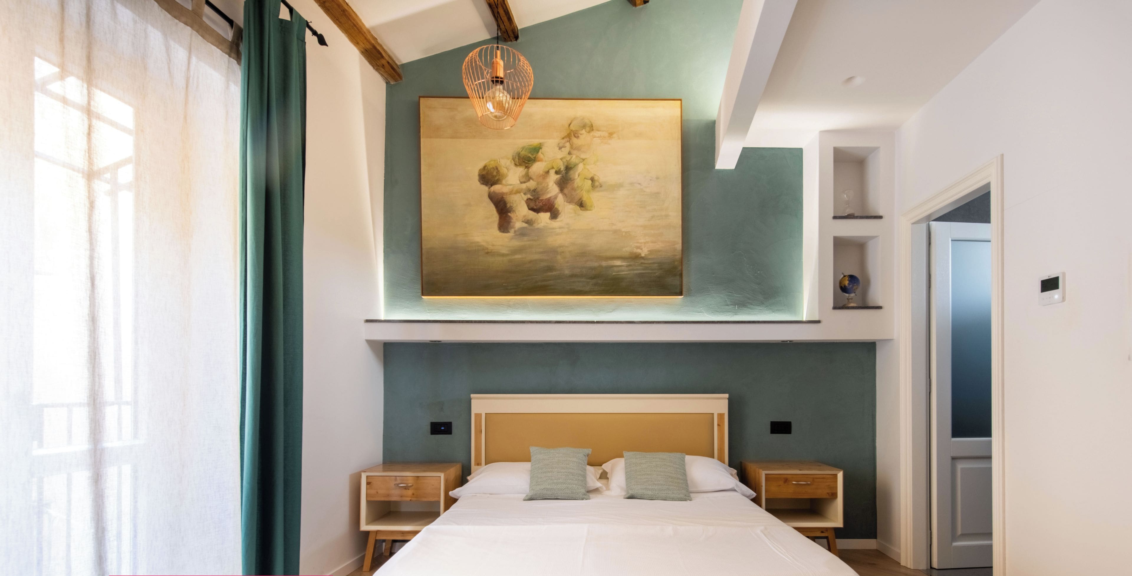 A modern bedroom with a large bed, bedside tables, a painting on the wall, and a view of a door.