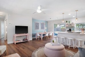 Relax in this stylish living space with a central seating area, dining area, and fully equipped kitchen.