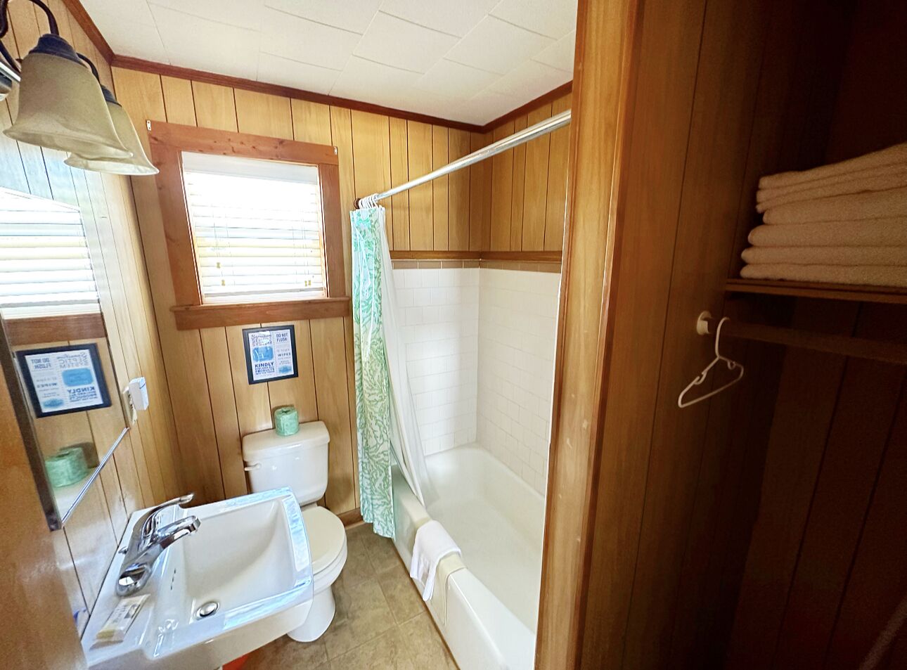 A bathroom with a sink, toilet, and bathtub.