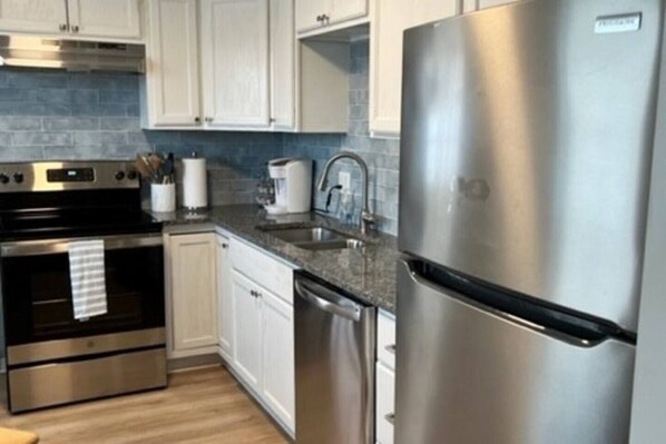Enjoy cooking in this well-equipped kitchen with a refrigerator, oven, and dishwasher.