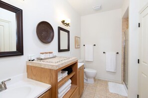 Bathroom features a vanity, mirror, and wall-mounted light fixture.