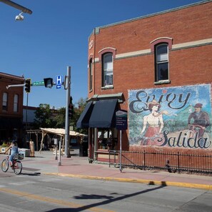 Experience the vibrant local culture in Salida, surrounded by historic murals and a lively street scene.