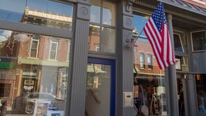 A building with large windows and an American flag. - Downstream Loft - Historic Savory Building (Salida)