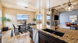 A modern kitchen with granite countertops, a built-in dishwasher, and pendant lighting. - The Overlook - Triple Primary Luxe, 50 Mile Views (Page)