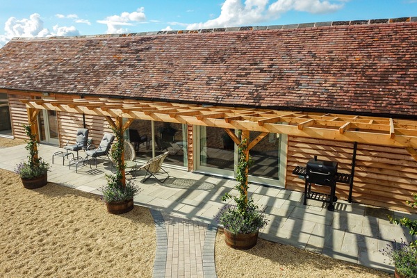Large patio with sun loungers, picnic bench and BBQ