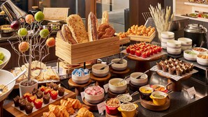 A buffet with various food items including bread, pastries, and bowls of different foods. - Pullman Singapore Hill Street (Singapore)
