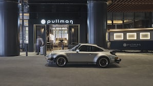 A silver sports car parked in front of a building with a 'pullman' sign. - Pullman Singapore Hill Street (Singapore)