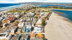 An aerial view of a coastal town with a beach, residential buildings, and a marina. - Baybreeze-3bd, 2ba, sleep 8 (San Diego)