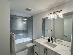 Shower, hair dryer, towels, soap