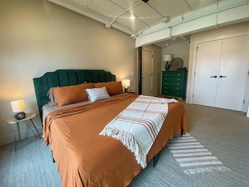 King size bed, a Smart TV, two night stands with lamps, a dresser, and a closet. All the makings of a perfect bedroom.