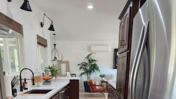 A modern kitchen with stainless steel appliances, wooden cabinets, and a central island. - Casita dos Robles Fallbrook's Favorite Dog-friendly Country Escape (Fallbrook)
