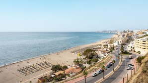 A coastal cityscape with a beach, buildings, and a road. - Spectacular sea views parking and pool  REF006 (Benalmádena)