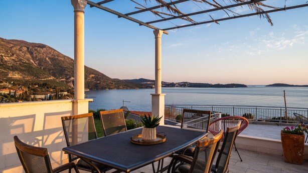 A terrace with a table and chairs, overlooking a body of water and hills. - Apartments Sandito - Two Bedroom Apartment with Terrace and Sea View (Mlini)