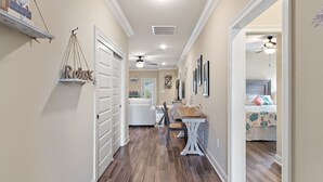 A hallway with a dining area and a bedroom. - Screened pool+Climate controlled game room+Outdoor TV+Fire pit+ Near the beach! (Navarre)