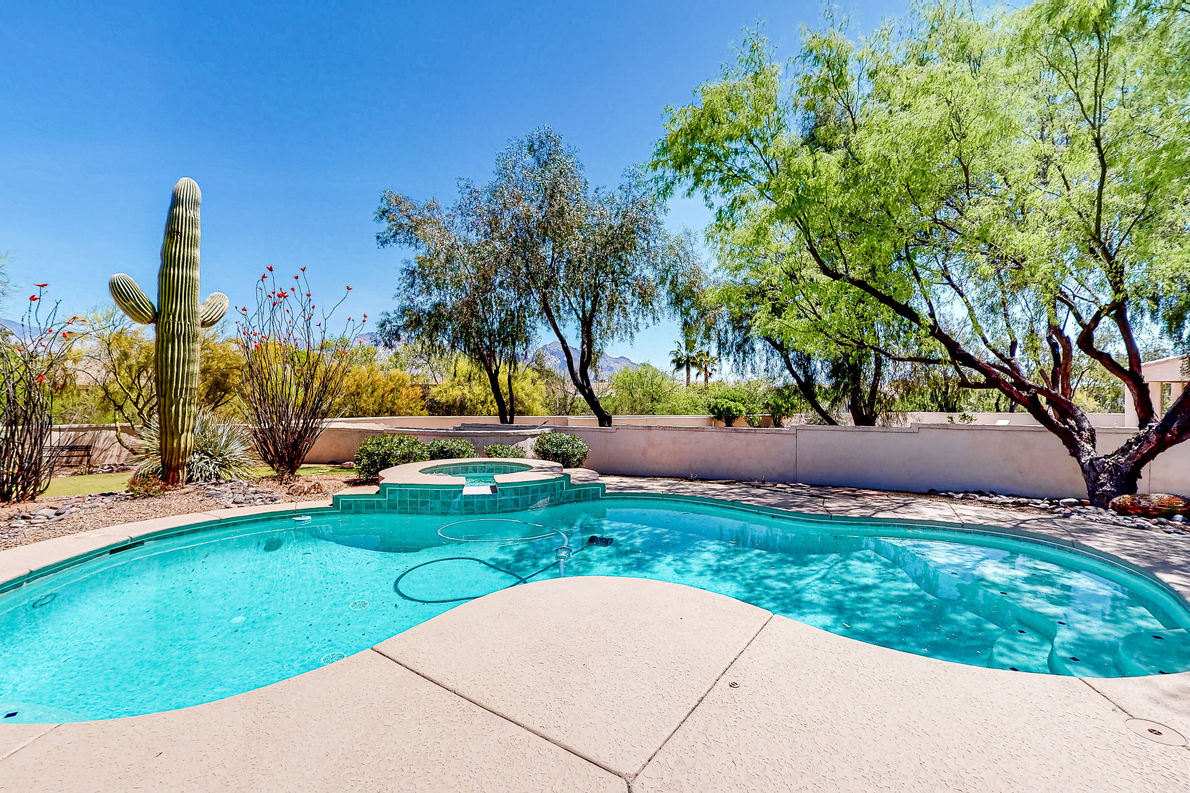 Spacious acreage home with a pool, hot tub, and putting green - mountain views